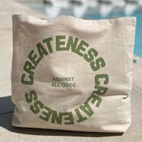 greatness against all creeds tote bag