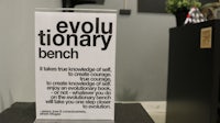 a sign that says evolutionary bench on top of a table