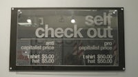 a sign that says self check out
