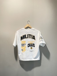 a white t - shirt with the word miltia on it
