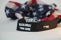 a black belt with the words decolonize your mind