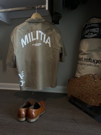 a pair of shoes and a shirt with the word miltia on it